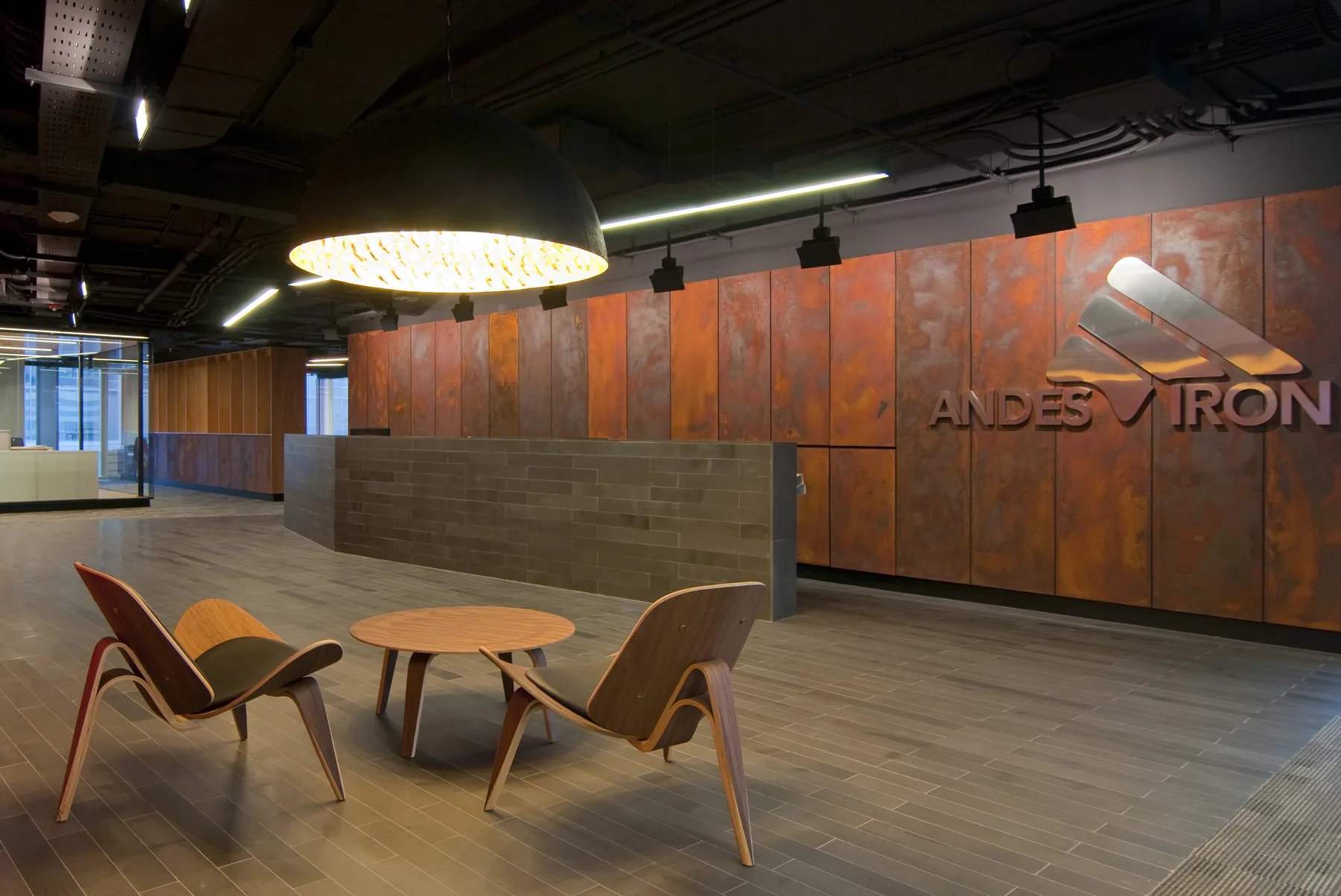 Recepción de las oficinas Andes Iron con muro de acero corten